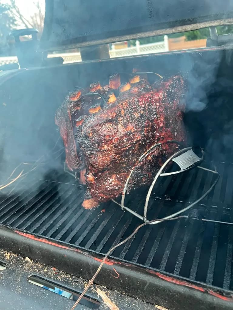 A smoked roast developing color over the grill